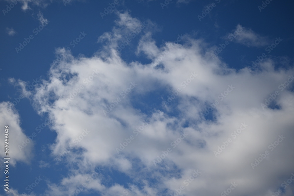 spring white clouds against the blue sky background summer cloudy sky spring white clouds against the blue sky background summer cloudy sky