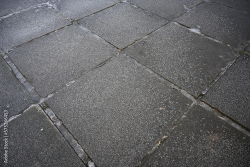 asphalt soviet square concrete tile, asphalt tile covered with thin ice crust, icy ice tile, concrete tile texture on asphalt, bituminous old concrete pavement, gray concrete pavement texture photo