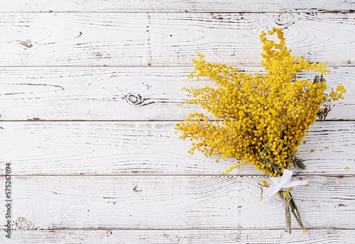 yellow mimosa flowers bouquet on wooden bakground