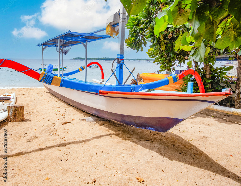 Junkung boat on beach in Bali, Indonesia with blue sky