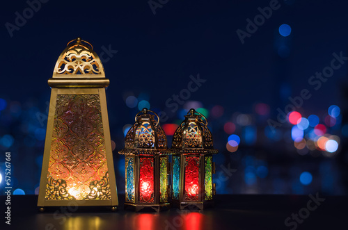 Selective focus on big lantern with night sky and city bokeh light background for the Muslim feast of the holy month of Ramadan Kareem.