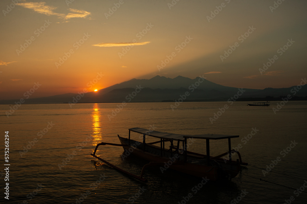 Wooden boat on sea in the morning against sunrise in Nusa Penida