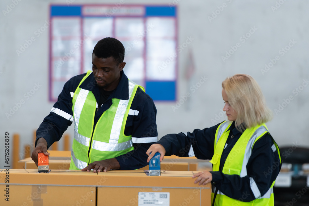 Group of worker in auto parts warehouse Packing small parts in boxes after inspecting the car parts that are ready to be sent to the car assembly plant. Group of worker in auto parts warehouse Packing small parts in boxes after inspecting the car parts that are ready to be sent to the car assembly plant.