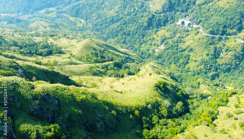 Aerial view of the green hills and gorge. Beautiful mountain background texture for tourism and advertising. Tropical landscape from a drone