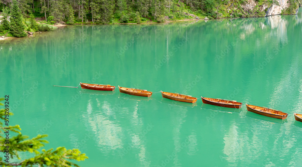 Amazing view of the famous Braies Lake in Italy. Typical rowing boats ...
