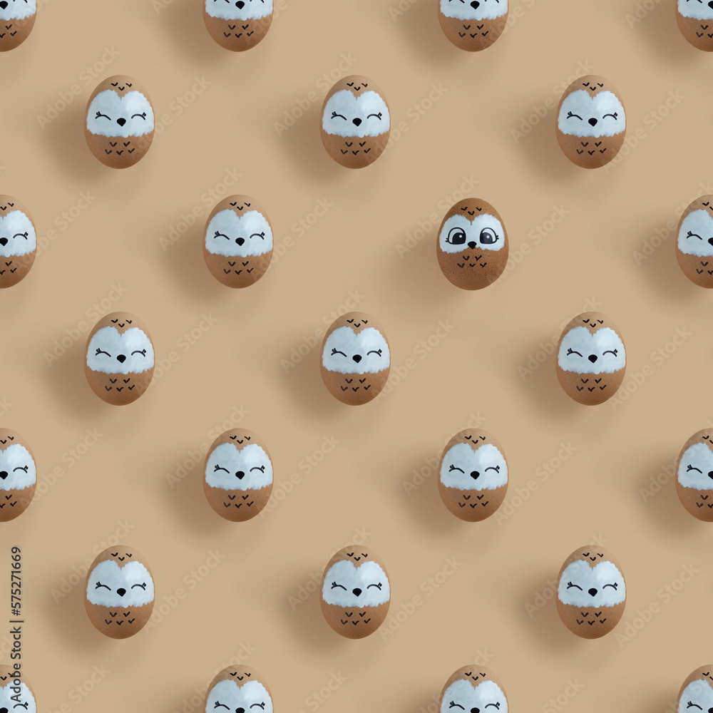 Pattern of decorated Easter eggs as owls on pastel beige background Pattern of decorated Easter eggs as owls on pastel beige background