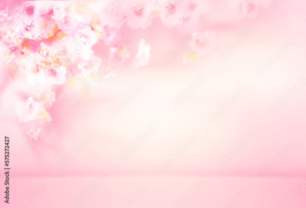 Spring summer blurred light pink background with shadow of the flowers and leaves of blossom tree on a wall. Abstract Spring Summer scene for product presentation.