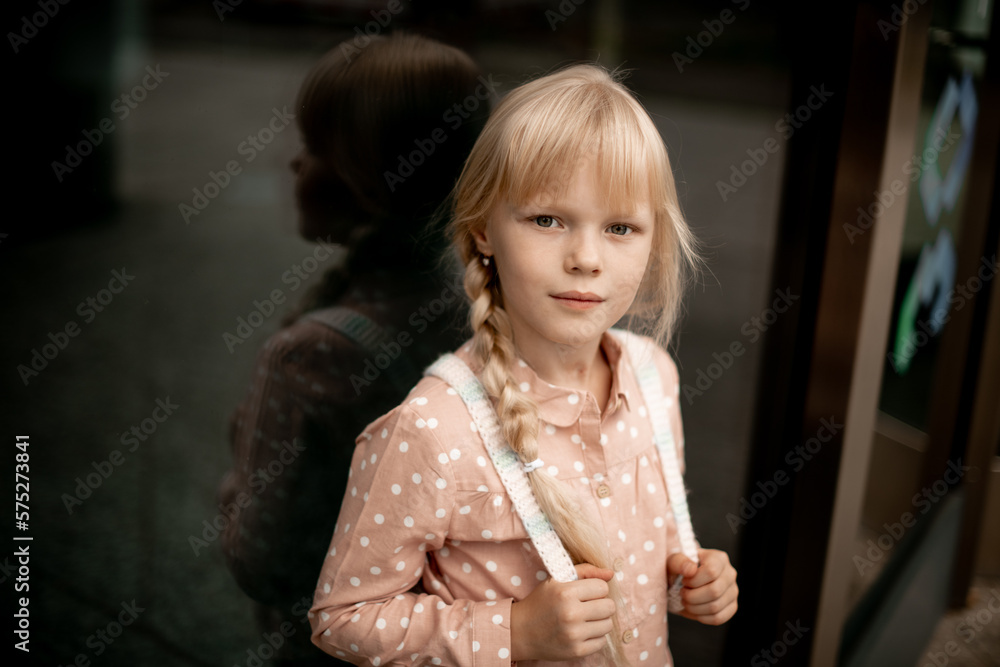 Portrait of a beautiful blonde girl in a shirt on a dark background on the street. Portrait of a beautiful blonde girl in a shirt on a dark background on the street.