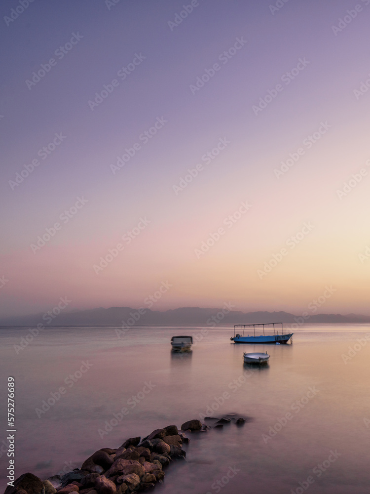 boats in water at sunrise