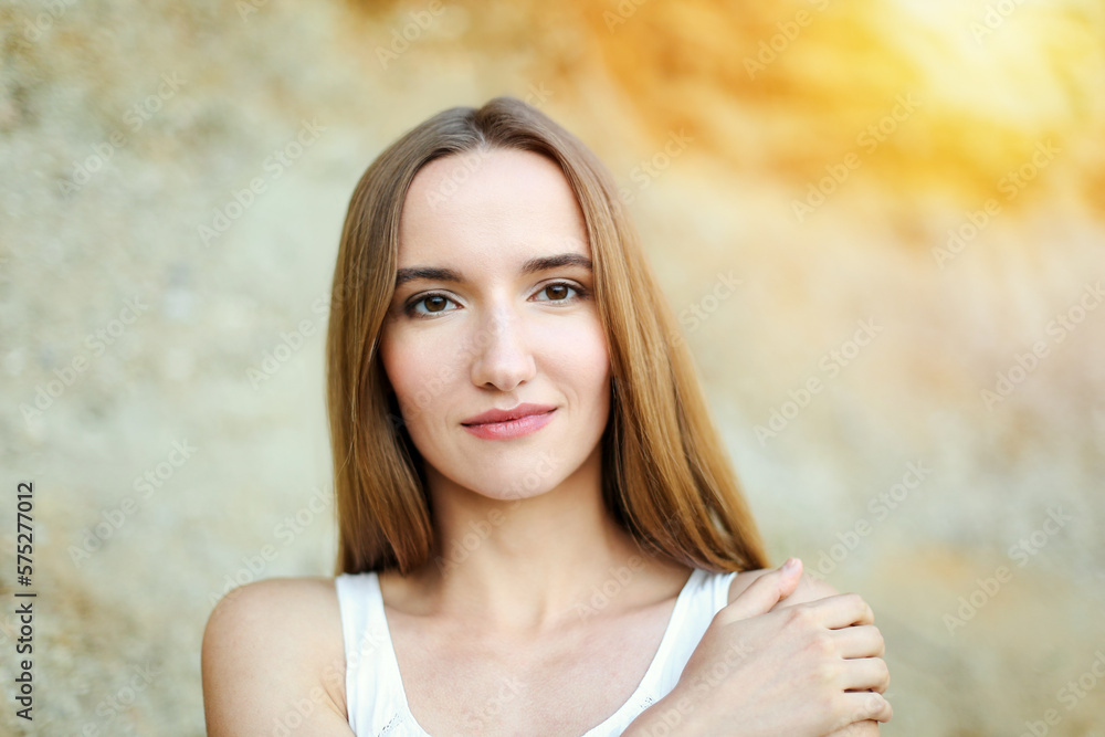 Portrait of a happy smiling woman standing and looking at the camera in a summer day Portrait of a happy smiling woman standing and looking at the camera in a summer day