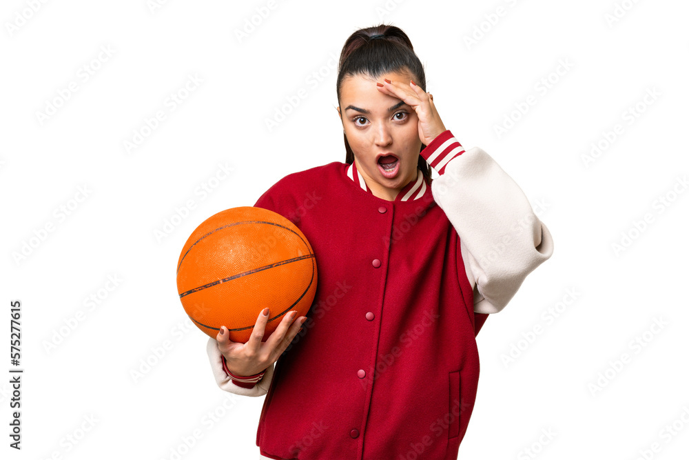 Young Woman playing basketball over isolated chroma key background doing surprise gesture while looking to the side Young Woman playing basketball over isolated chroma key background doing surprise gesture while looking to the side