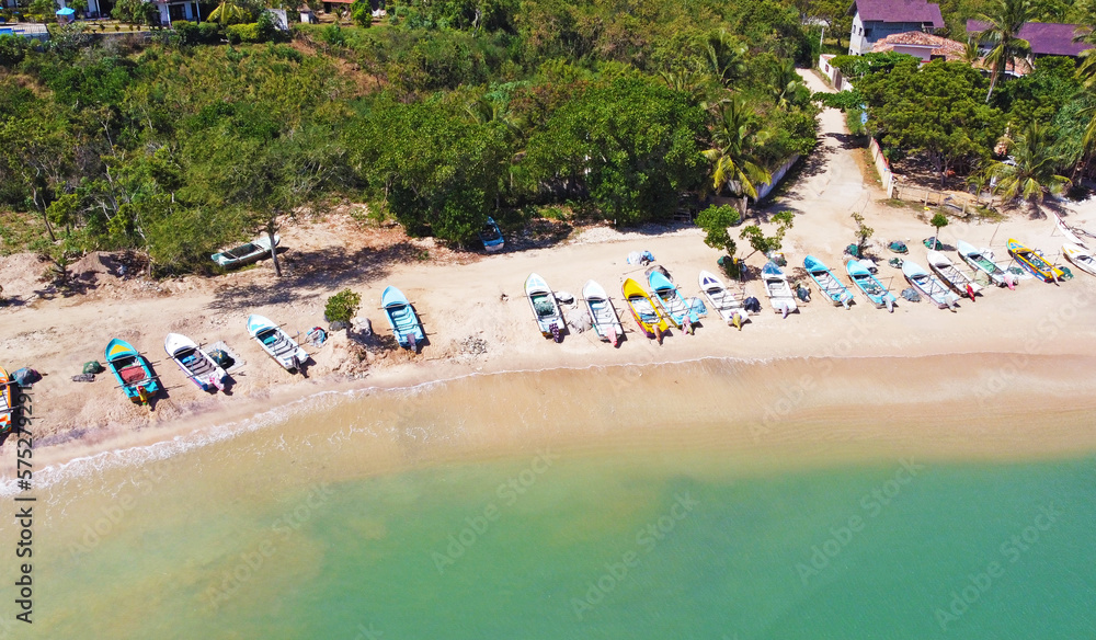 Aerial view of colorful fishing boats on the ocean. Beautiful Asian texture background for tourism and advertising. Tropical landscape from a drone Aerial view of colorful fishing boats on the ocean. Beautiful Asian texture background for tourism and advertising. Tropical landscape from a drone