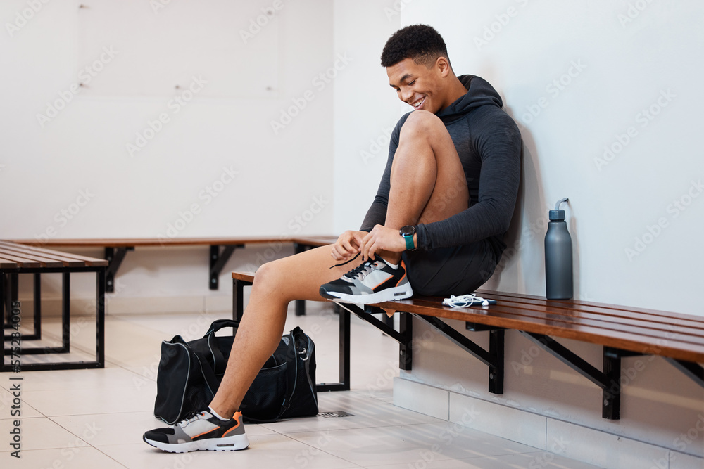Fototapeta premium Fitness, tying shoes and black man in locker room for training, sports and gym workout. Exercise, health and start cardio with athlete and dressing sneakers for gear, wellness or ready for practice