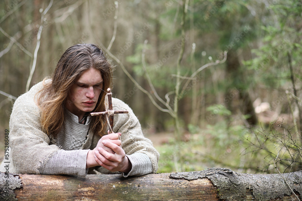 A man in a cassock spends a ritual in a dark forest A man in a cassock spends a ritual in a dark forest
