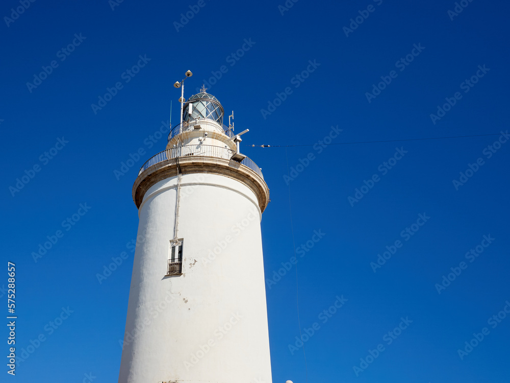 Lighthouse, called La Farola, in an area called La Malagueta. Harbor of Malaga. Costa del Sol, Andalusia, Spain, Europe Lighthouse, called La Farola, in an area called La Malagueta. Harbor of Malaga. Costa del Sol, Andalusia, Spain, Europe