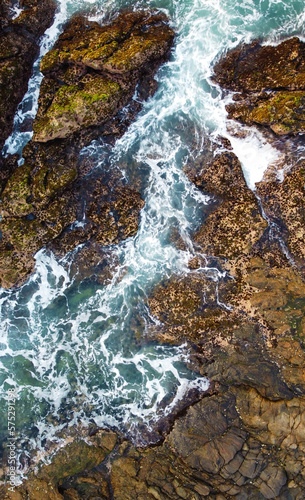 Aerial view of the sea rocks cliffs in the ocean. Beautiful sea wallpaper for tourism and advertising. Stormy landscape, drone photo