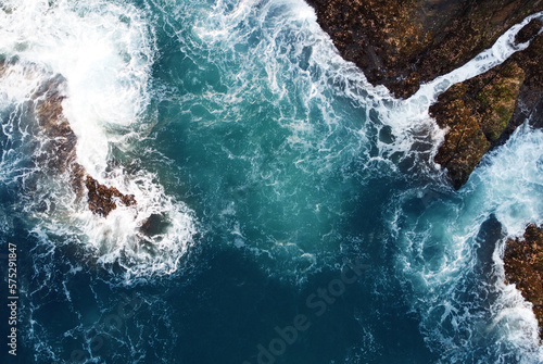 Aerial view of the sea rocks cliffs in the ocean. Beautiful sea wallpaper for tourism and advertising. Stormy landscape, drone photo