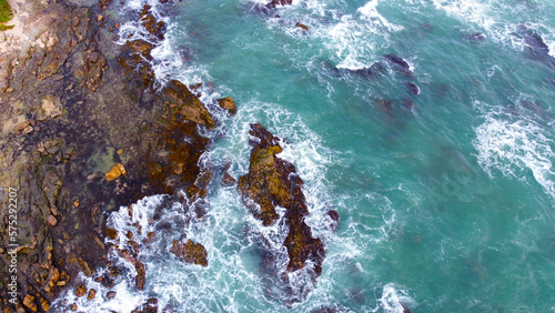 Aerial view of the sea rocks cliffs in the ocean. Beautiful sea wallpaper for tourism and advertising. Stormy landscape, drone photo