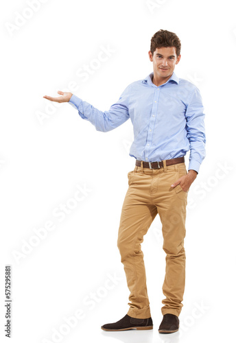 Portrait, isolated and man presenting space for product placement for marketing or advertising. Mockup, hand gesture and happy model showing info for deal in studio on white background.