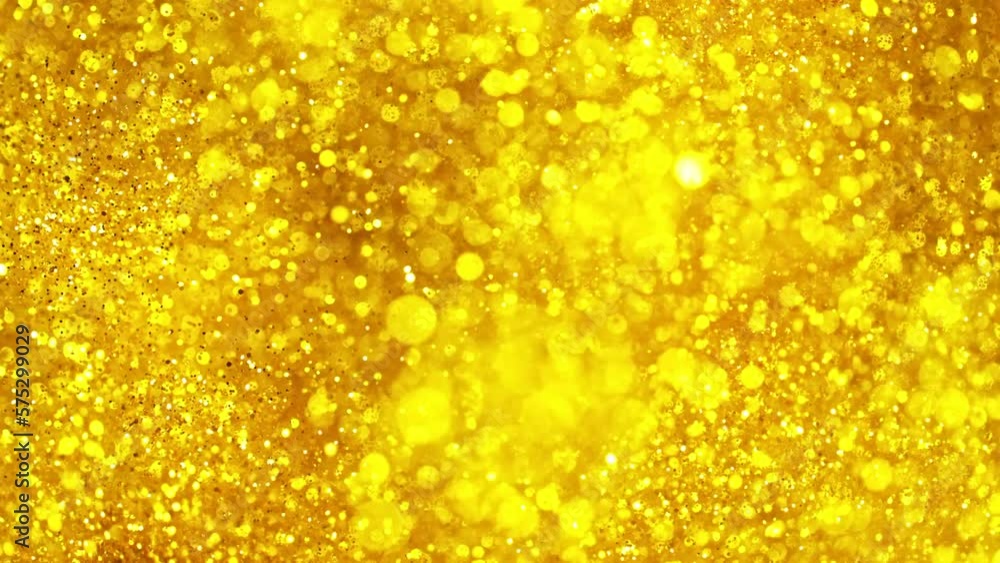 Super slow motion of glittering golden particles. Shallow depth of focus. Filmed on high speed cinema camera, 1000 fps. Super slow motion of glittering golden particles. Shallow depth of focus. Filmed on high speed cinema camera, 1000 fps.