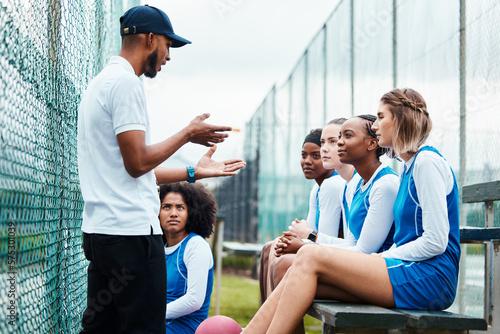 Netball plan, sports team and coach explain game strategy, teamwork collaboration talk or planning competition idea. Coaching athlete, substitute bench and group of people listen to fitness challenge