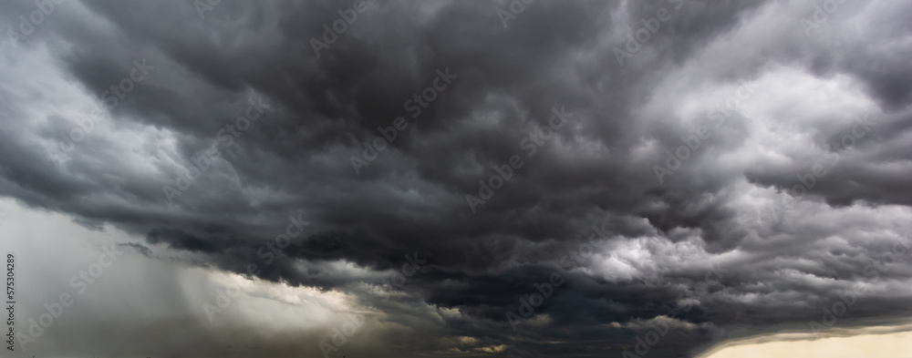 The dark sky with heavy clouds converging and a violent storm before the rain.Bad or moody weather sky and environment. carbon dioxide emissions, greenhouse effect, global warming, climate change The dark sky with heavy clouds converging and a violent storm before the rain.Bad or moody weather sky and environment. carbon dioxide emissions, greenhouse effect, global warming, climate change