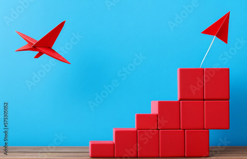 Wooden block stacking as step stair with red paper plane on blue background, Ladder of success in business growth concept, copy space
