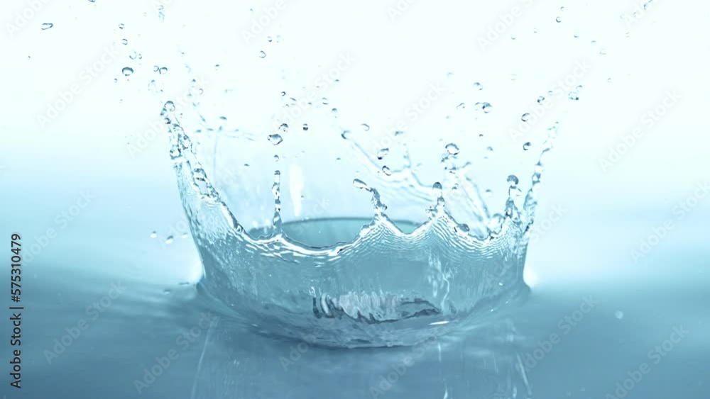 Super slow motion of splashing water in crown shape, isolated on blue background. Filmed on high speed cinema camera, 1000 fps. Super slow motion of splashing water in crown shape, isolated on blue background. Filmed on high speed cinema camera, 1000 fps.