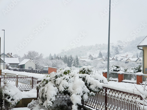 white houses and trees - village Milanovac under snow. Winter in Croatia photo