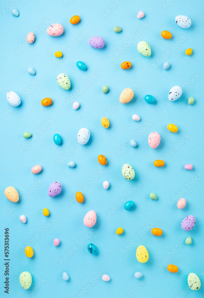 Easter Eggs with Sweets and Spring Flowers on Blue Background Easter Eggs with Sweets and Spring Flowers on Blue Background