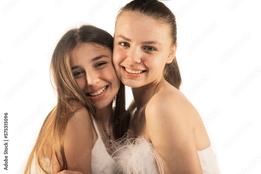 Lovely girls, sisters, hugging each other isolated on white background Lovely girls, sisters, hugging each other isolated on white background