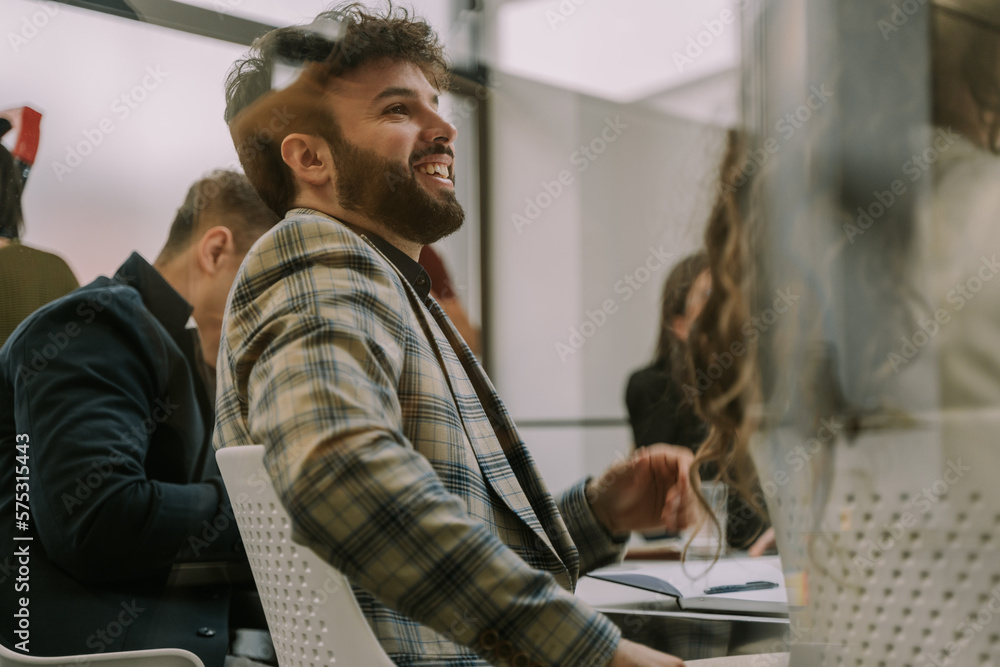 Fototapeta premium A young good looking male business person smiling