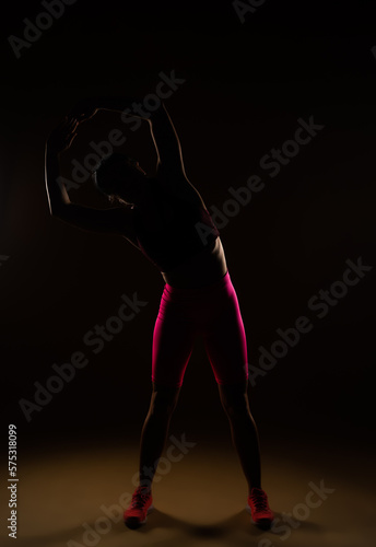 Fototapeta Naklejka Na Ścianę i Meble -  Female sports person warming up her body