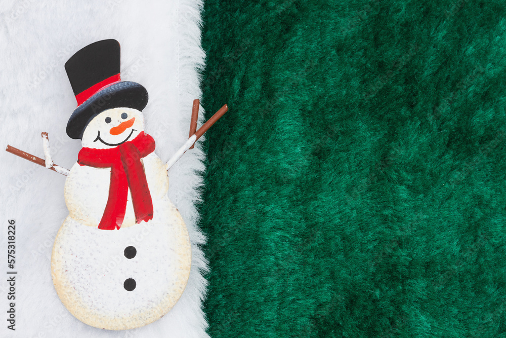 Fototapeta premium Snowman with green fleece material with white border
