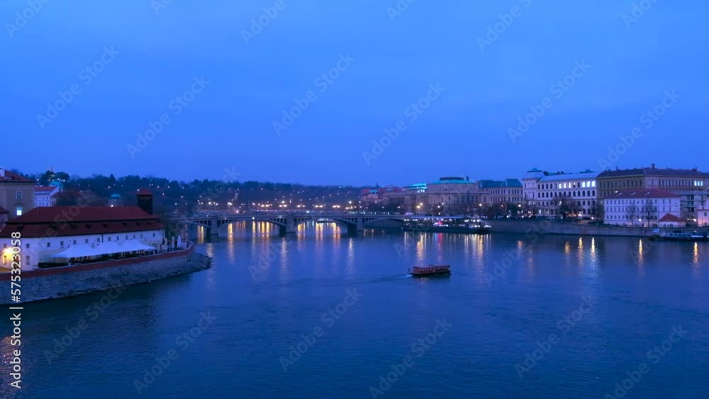 Vltava River and city with buildings, boats on river, Czech Republic Vltava River and city with buildings, boats on river, Czech Republic