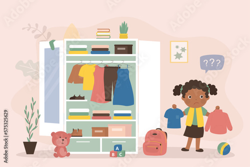 Cute kid girl select various clothes in storage. Wardrobe, organizing space for clothing. Fashion african american child. Shelves with apparel and outfit, accessories and boots