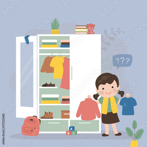 Cute kid girl select various daily clothes in storage. Wardrobe, organizing space for clothing. Fashion caucasian child. Shelves with apparel and outfit, accessories and boots.