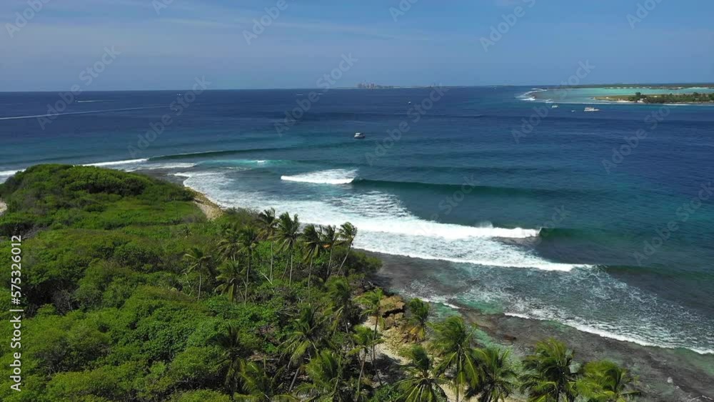 Aerial Panning Beautiful Shot Of Wavy Sea Under Sky, Drone Flying Over Tropical Trees On Island - Thulusdhoo, Maldives Aerial Panning Beautiful Shot Of Wavy Sea Under Sky, Drone Flying Over Tropical Trees On Island - Thulusdhoo, Maldives