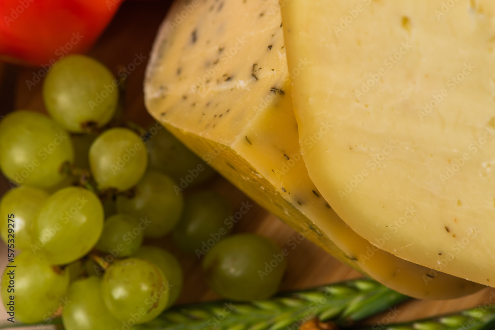 Bosnian traditional cheese served on a wooden container with peppers, parade and onions isolated on a white background Bosnian traditional cheese served on a wooden container with peppers, parade and onions isolated on a white background