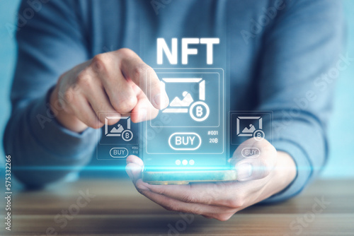 People buy NFT artwork via smartphone. Concept of non fungible token, blockchain technology, investment.