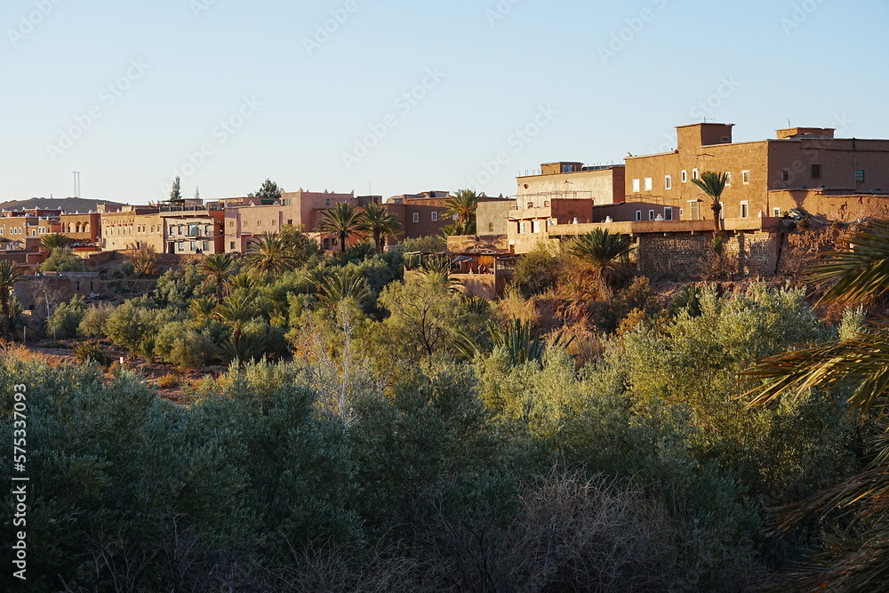 Trees and kasbah Ait Ben Haddou at Atlas Mountains in Morocco