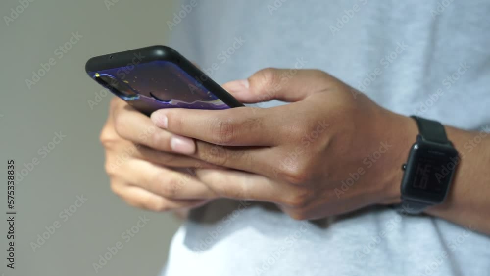 Asian man using smartwatch and smartphone Asian man using smartwatch and smartphone