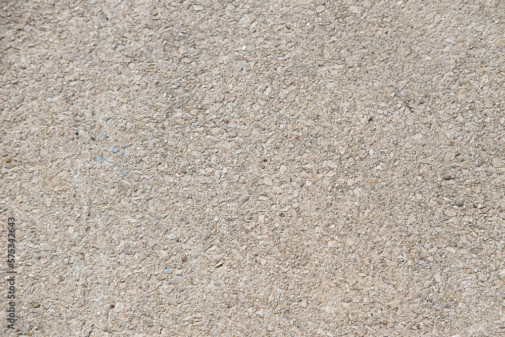 Beige cement texture on the street. Stone table background. Beige cement texture on the street. Stone table background.