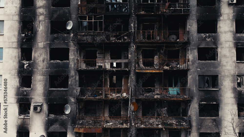 A burnt-out high-rise in the war zone. Damage to a residential building as a result of artillery shelling. War in residential areas, broken windows and burned apartments. Armed conflict in Ukraine