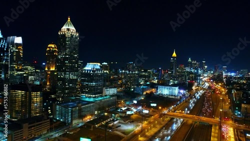 Aerial Shot Of Residential Buildings, Drone Flying Forward Over Cars Moving On Roads In Illuminated City - Atlanta, Georgia