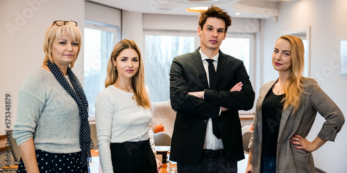 A team from different generations stands representatively in an elegant office