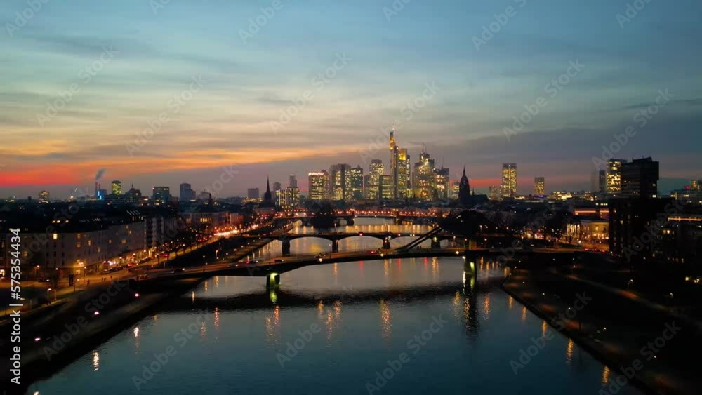 flying backwards over the river main with the skyline of frankfurt am main at sunset