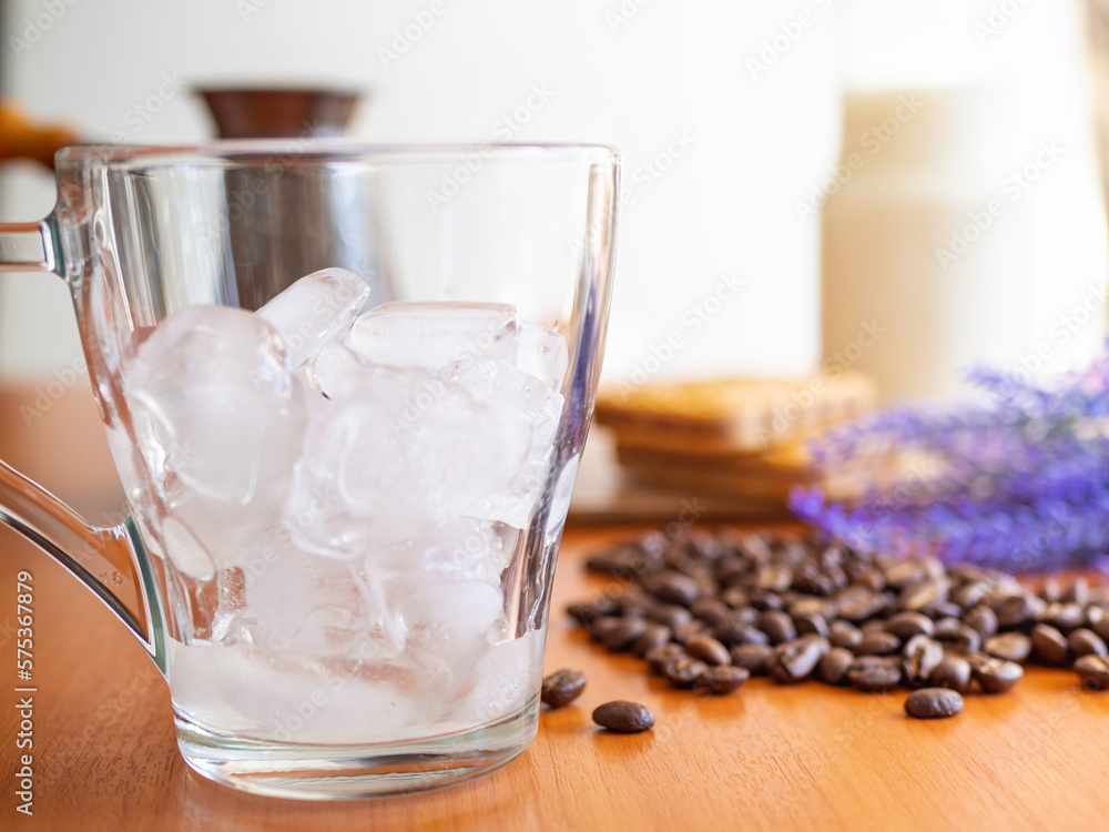 a glass of ice and coffee beans on a table, Cookies and milk bottle on background a glass of ice and coffee beans on a table, Cookies and milk bottle on background