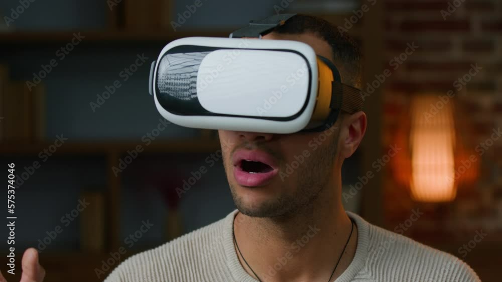 African american latino man gamer in VR goggles play game use virtual reality augmented glasses watching real simulation gaming modern 3d metaverse technology amazed ethnic millennial playing indoors African american latino man gamer in VR goggles play game use virtual reality augmented glasses watching real simulation gaming modern 3d metaverse technology amazed ethnic millennial playing indoors