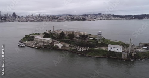 Aerial view of Alcatraz island in the San Francisco Bay. USA. The most famous Alcatraz Prison, Jail. Sightseeing Place. Tourists Ferry in Foreground